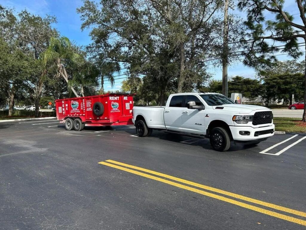 White T & R Dumpster Rentals truck with red 17-yard dumpster trailer in Loxahatchee, Florida