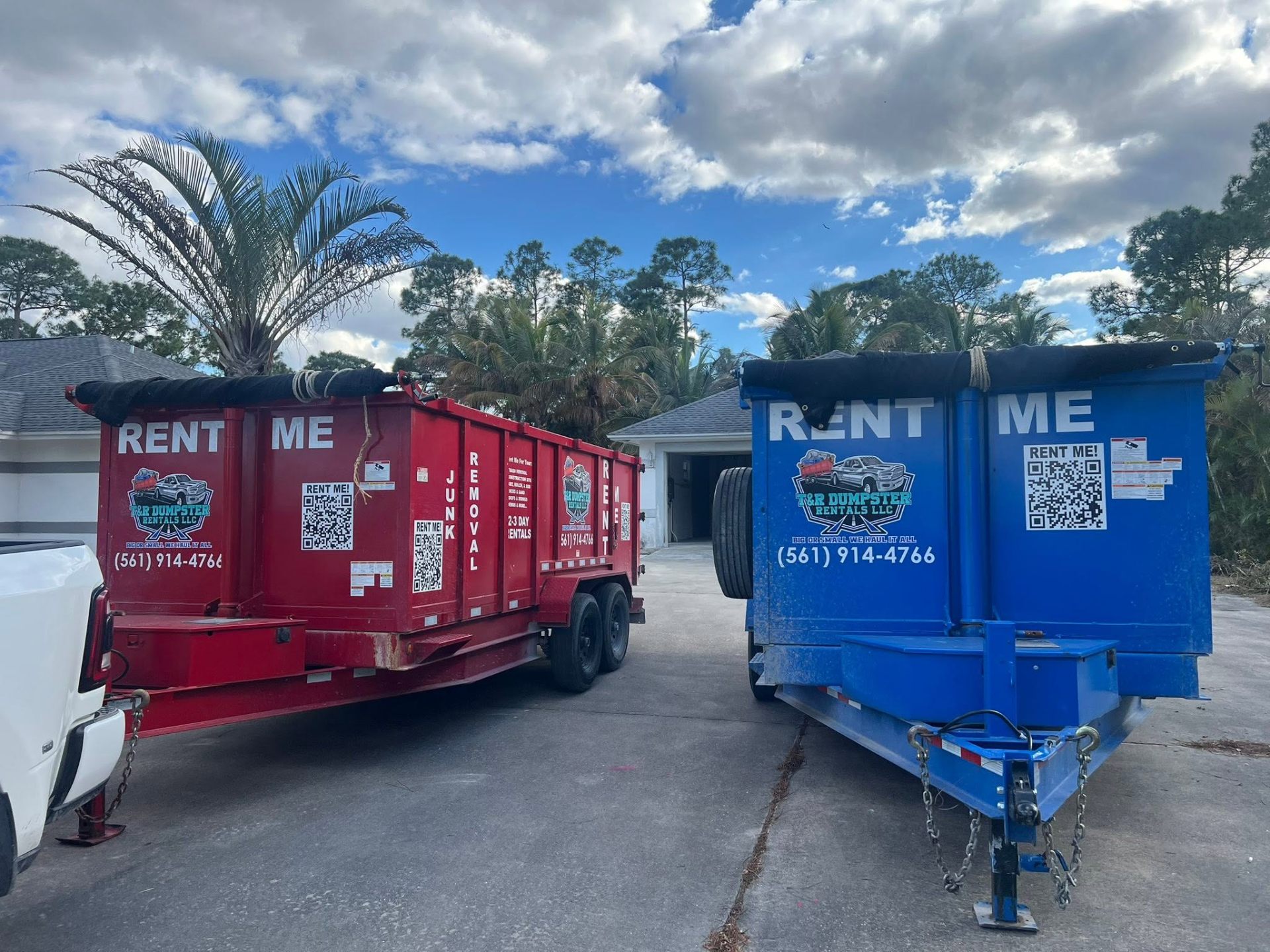 Two 17-yard dump trailers parked together for T & R Dumpster Rentals.