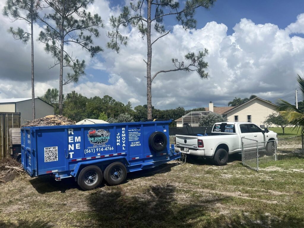 Blue 17-yard dump trailer loaded with branches and yard debris.