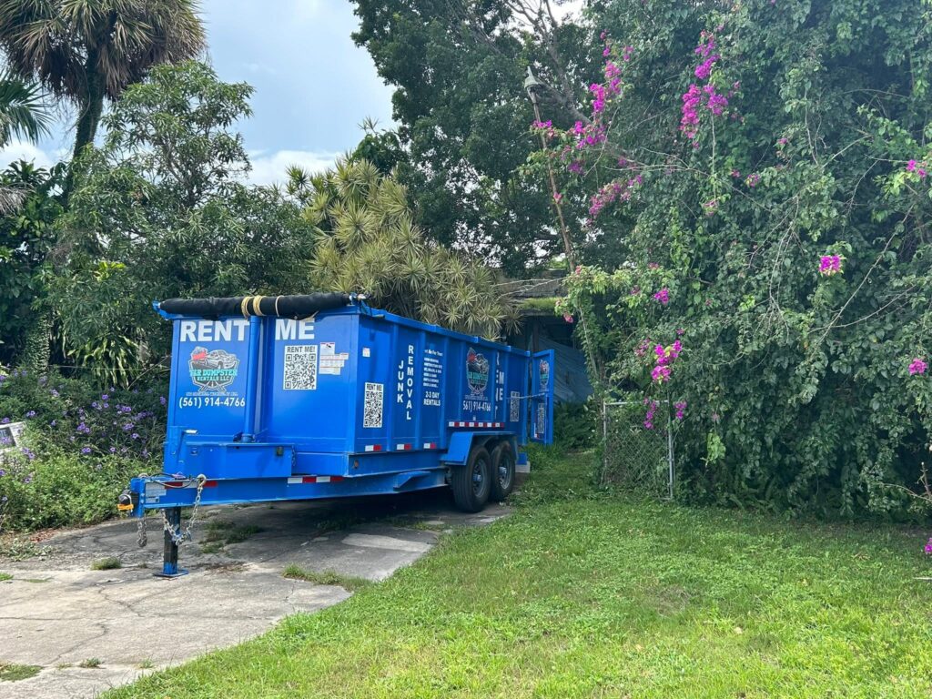 Driveway-safe 17-yard dump trailer parked in a residential driveway.